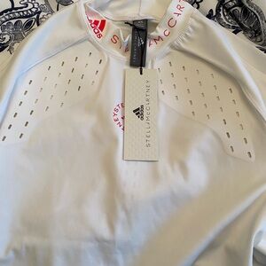 Adidas by Stella McCartney White Long-Sleeve Athletic Top with Pink Accents.